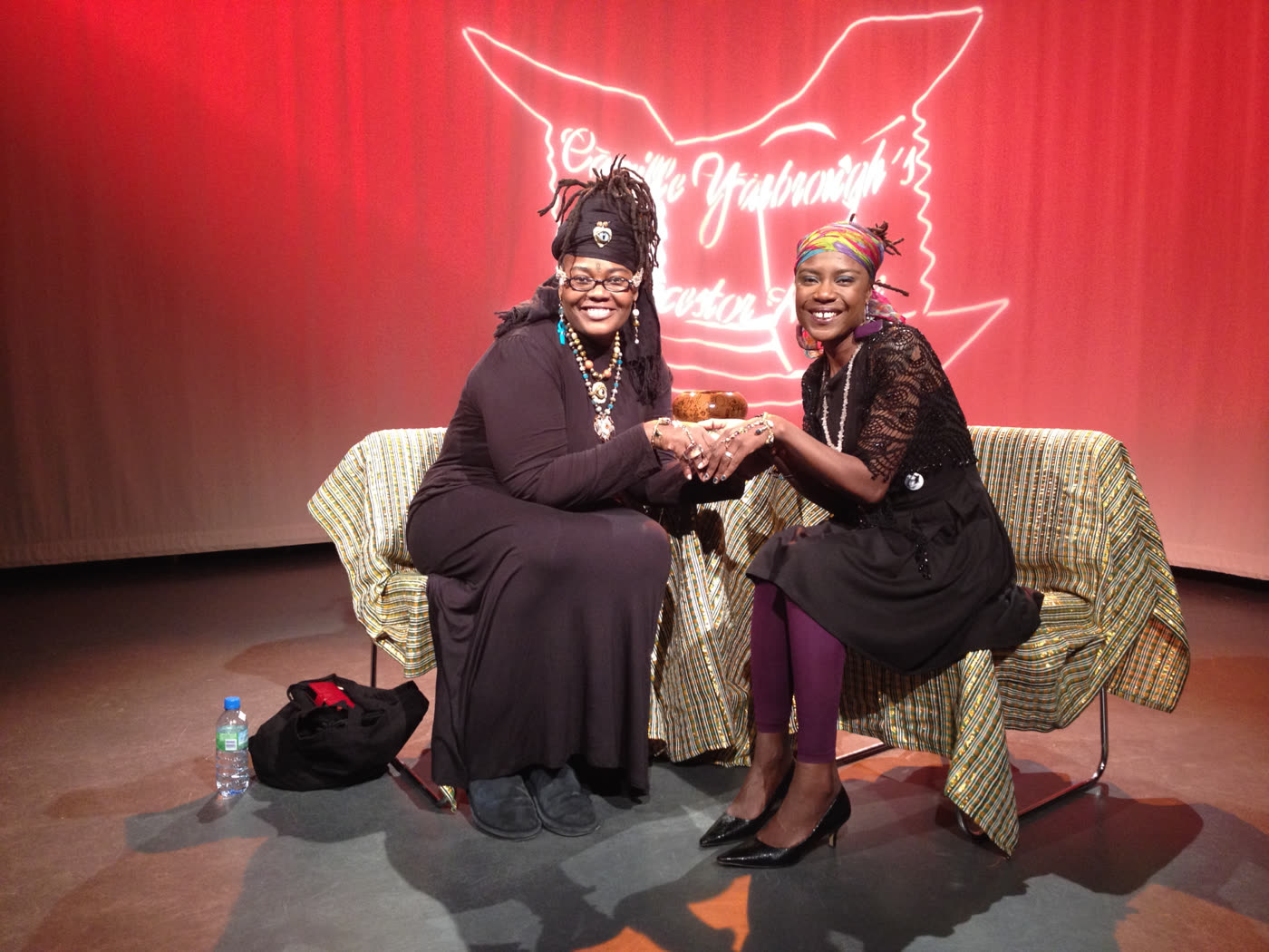Dami Rock with a guest on the red-curtain set of Ancestor House